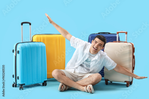 Male tourist with suitcases...