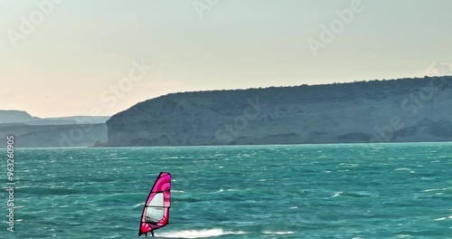 Scenic Air View of Windsurfing - Sailboard Riding Waves in Active Sea Sports. High quality 4k footage