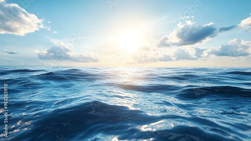 Blue ocean seawater surface with sky, clouds and sunshine, summer background concept 