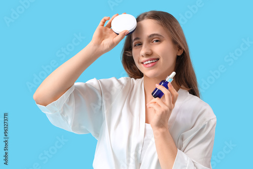 Young woman with facial cre...