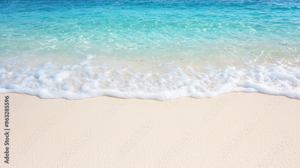 Clear ocean waves gently crashing on white sandy beach, peaceful and inviting seaside view