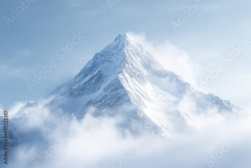 Snow covered mountain peak rises above clouds