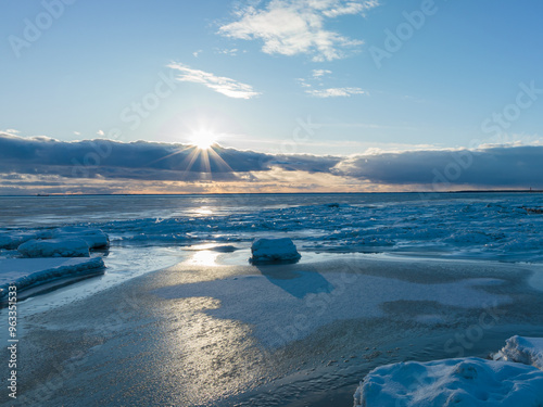 Winter at sea, sunset with ice, beautiful clouds