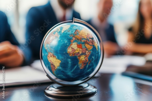 Wallpaper Mural A globe sits on a table in front of three businesspeople. The globe symbolizes international business and global connections. Torontodigital.ca