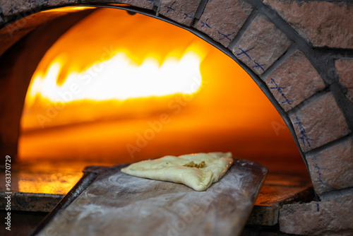 Old style middle east stone oven. Lebanese food Manakish baked in the stone oven  photo