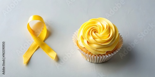 Flatlay yellow cancer ribbon cream cupcake with frosting on isolated background, perfect for supporting screening awareness month bake sale fundraiser event or hightea health campa photo