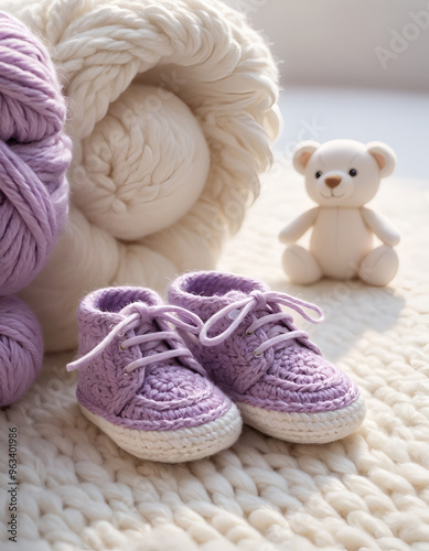 A baby pair of shoes, skillfully crocheted with a light purple and white yarn