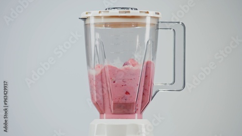 Photos Pieces of ripe bananas, kiwi and strawberries are mixed in a blender with milk