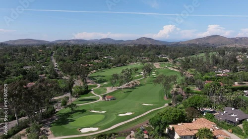 Aerial view of a luxury golf course in Rancho Santa Fe with views of the blue sky and luxury homes surrounding the area photo