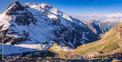 View during sunrise from Rupin pass trekking trail. This trek is full of diversity from majestic Himalayan ranges to waterfalls, glacial meadows, snow-covered landscapes in Himachal, India photo