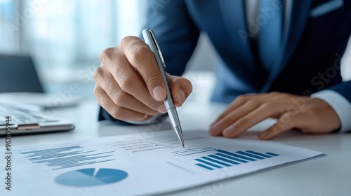 A businessman meticulously examines a business plan, carefully analyzing graphs and charts to make informed investment decisions. The image symbolizes financial planning, strategic analysis, data-driv