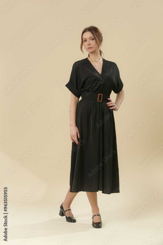 Serie of studio photos of young female model in soft cotton black midi dress. Serie of studio photos of young female model in soft cotton black midi dress.