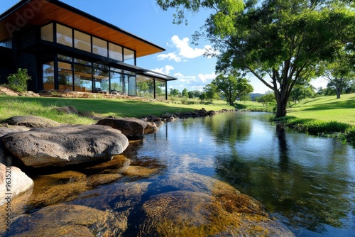 Country house nestled by a river, water gently flowing as the summer heat shimmers in the distance