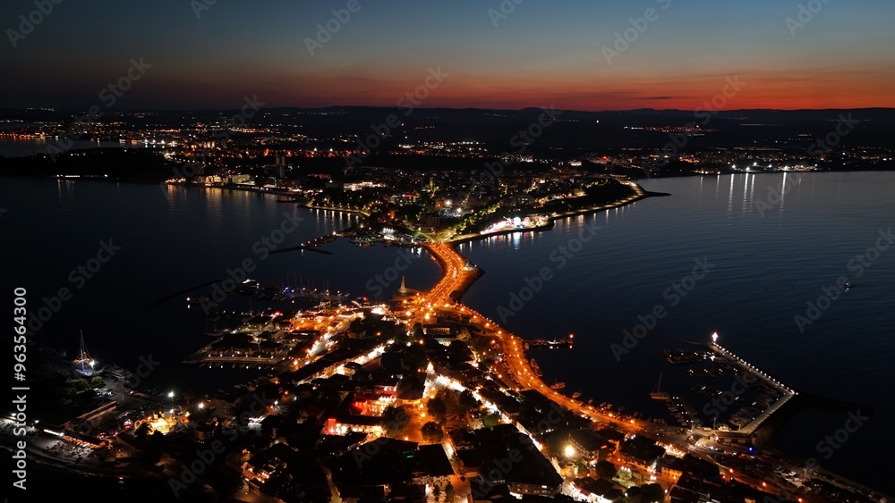 Experience Nesebar's enchanting nightlife. Our drone photos showcase the stunning juxtaposition of the old town's historic charm and the new town's vibrant energy. Experience Nesebar's enchanting nightlife. Our drone photos showcase the stunning juxtaposition of the old town's historic charm and the new town's vibrant energy.