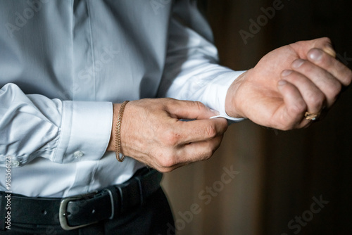 Elegant Close-Up of a Man Adjusting Shirt Cuff for Formal Attire Preparation