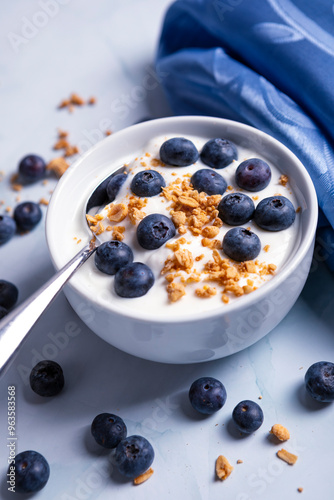 Healthy light diet breakfast of blueberries and yogurt and crunchy granola