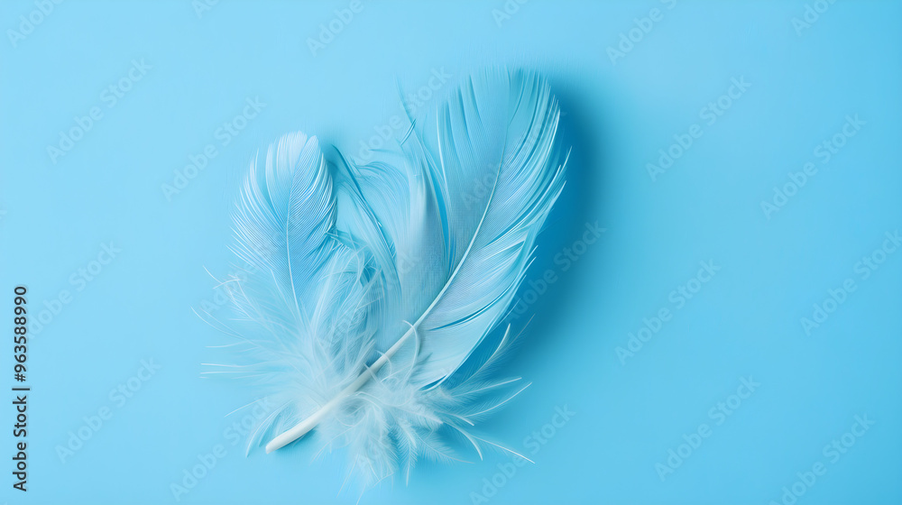 Obraz premium Vibrant blue feather perfectly contrasted against a soft, powdery blue backdrop in a stunning display.