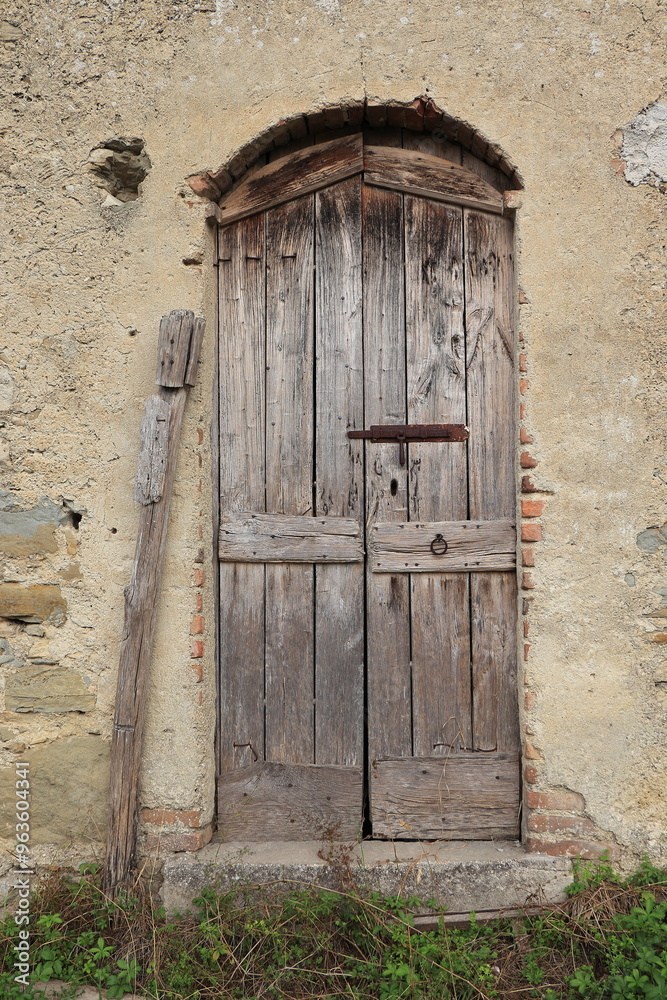 Old Wooden Barn Door in a Countryside Village in Central Italy Old Wooden Barn Door in a Countryside Village in Central Italy