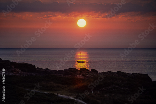 Vintage photograph of a sunset over the sea with yacht
