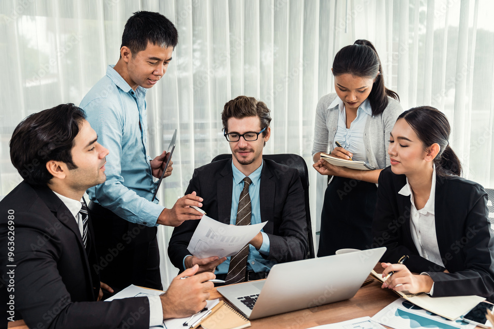 Diverse of business people from various ethnic group working in modern office environment. Productive and multi ethnic office workers engage in discussion for strategic business marketing. Meticulous Diverse of business people from various ethnic group working in modern office environment. Productive and multi ethnic office workers engage in discussion for strategic business marketing. Meticulous