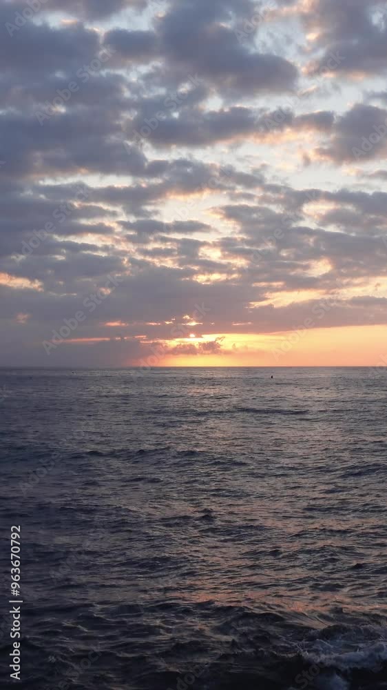 Vertical video of stunning dawn between clouds at blue hour over the water of the Mediterranean Sea horizon
Vertical video of stunning dawn between clouds at blue hour over the water of the Mediterranean Sea horizon