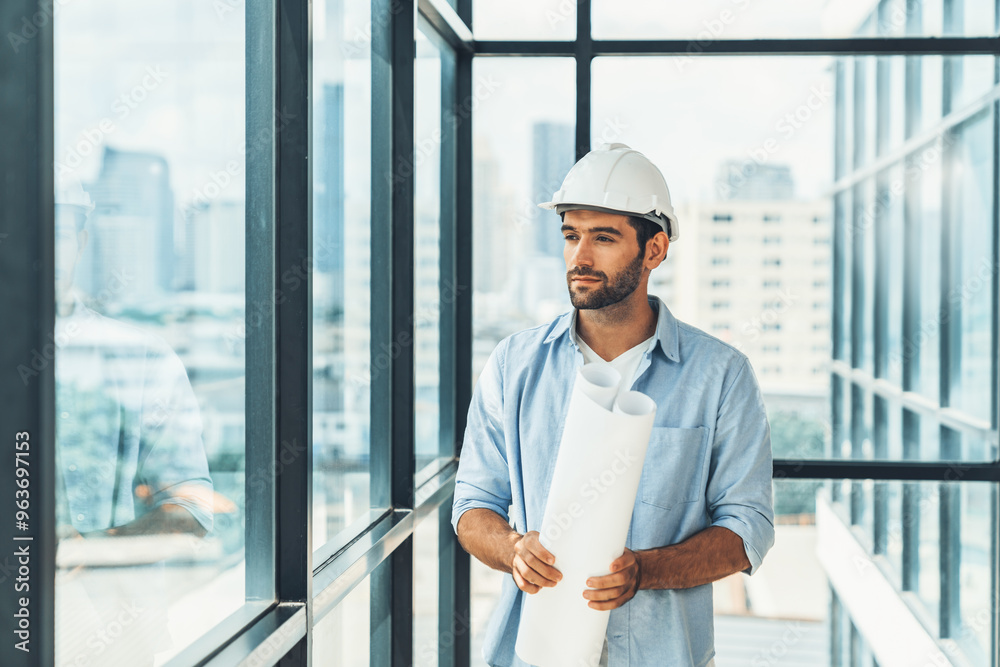 Professional architect engineer or male worker in casual outfit looking at skyscraper and city view while holding project plan. Creative design, civil engineering, building construction. Tracery. Professional architect engineer or male worker in casual outfit looking at skyscraper and city view while holding project plan. Creative design, civil engineering, building construction. Tracery.