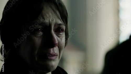 Emotionally victimized. Abused young woman crying hard and covering her mouth.