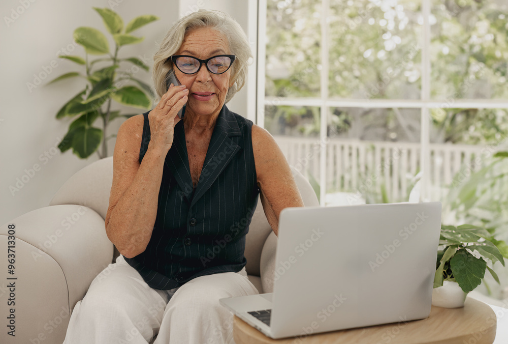 Fototapeta premium An elderly woman comfortably uses her laptop at home, surrounded by a vibrant array of lush greenery and plants