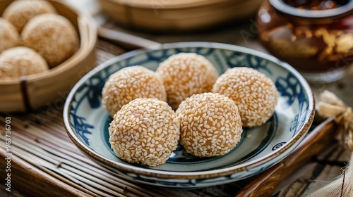 Delightful Sesame Balls: A Traditional Asian Sweet Treat on a Wooden Table