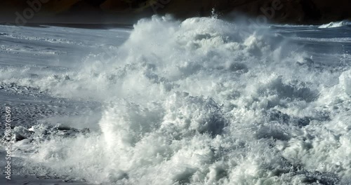 waves crashing at the beach in slow motion