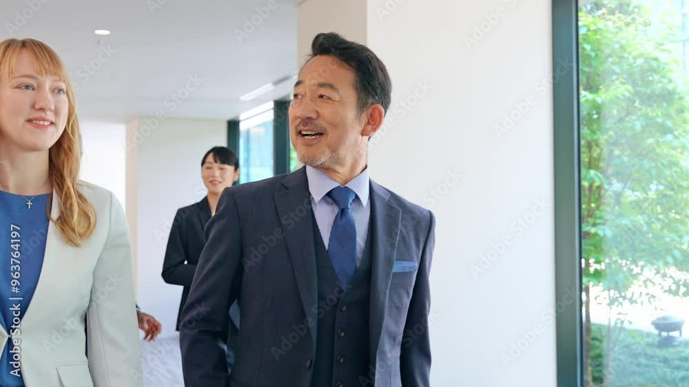 Group of multinational business people walking and talking inside a building Group of multinational business people walking and talking inside a building