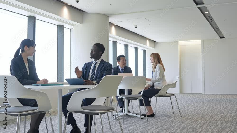 Group of multinational business people having a conversation in a lobby Group of multinational business people having a conversation in a lobby