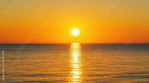 Golden sunset over a calm sea, clear weather, warm glow on the horizon