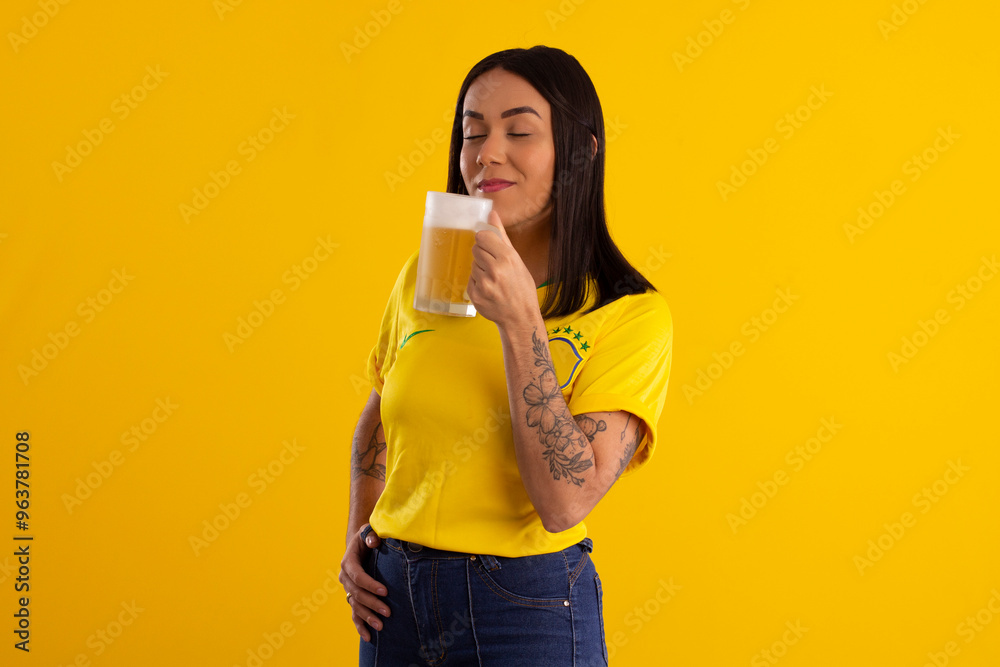 Young beautiful woman in yellow color shirt from Brazil holding a glass of beer in studio shot with various expressions of feelings Young beautiful woman in yellow color shirt from Brazil holding a glass of beer in studio shot with various expressions of feelings