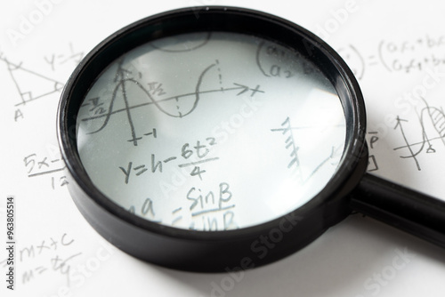 Fotografi Mathematical Equations and Graph with Magnifying Glass