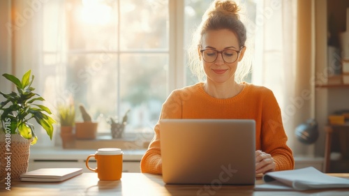 Woman in a bright home office, starting her telecommute day with a focused routine, working on a laptop with morning sunlight