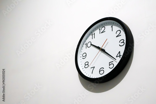 Wallpaper Mural Close-up of a black wall clock with black numerals and white background against a plain white wall. Concepts related to time, time management, schedules, deadlines, simplicity, and punctuality Torontodigital.ca