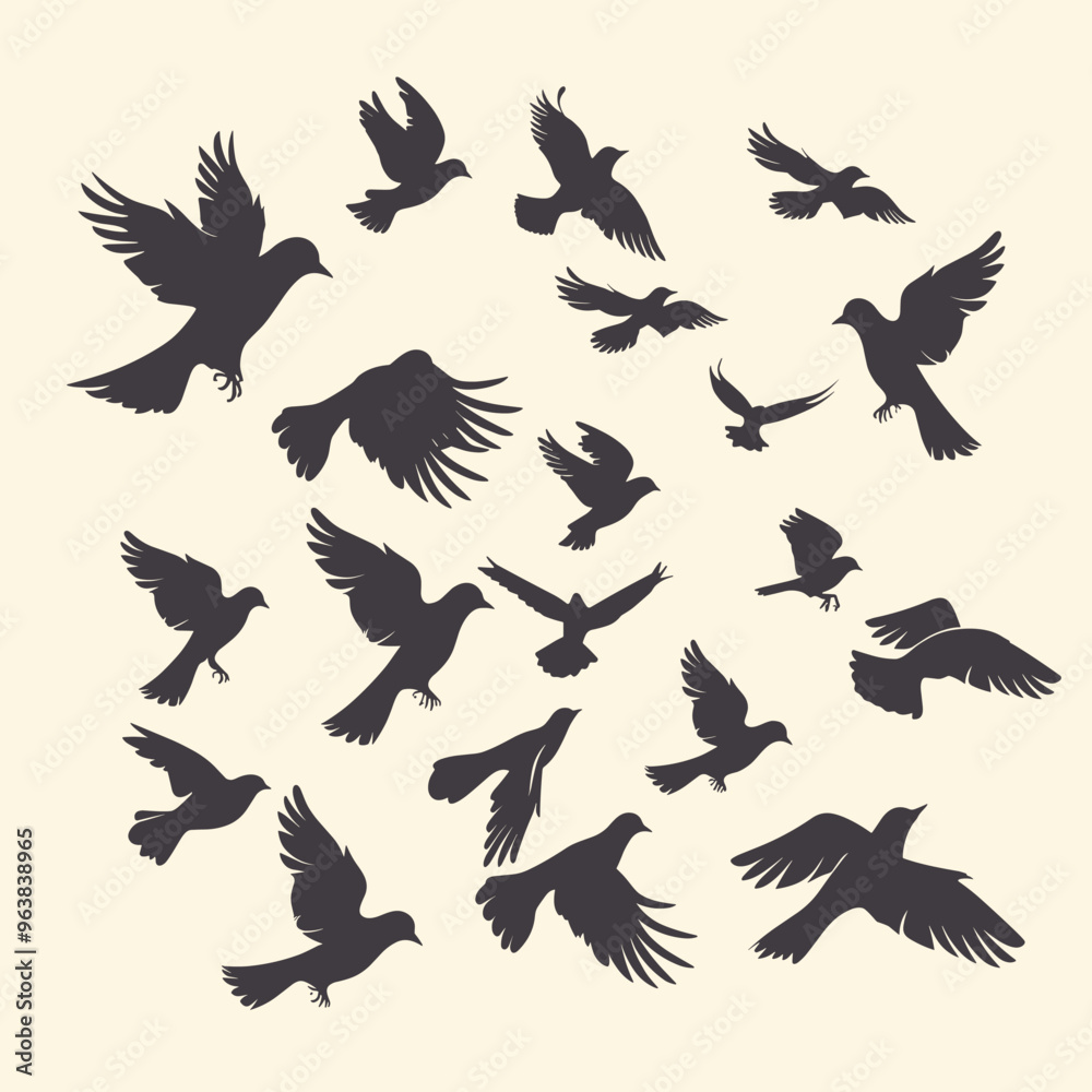 Fototapeta premium Silhouettes of various birds in flight against a light background.