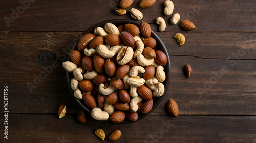 Mixed nuts on wooden background top views