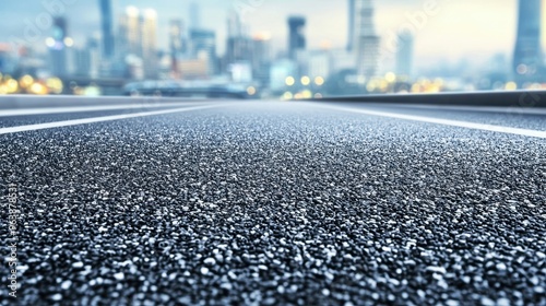 Asphalt Road with Blurred City Skyline in Background