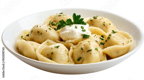 Delicious plate of dumplings served with sour cream and herbs, perfect for comfort food lovers and culinary enthusiasts.