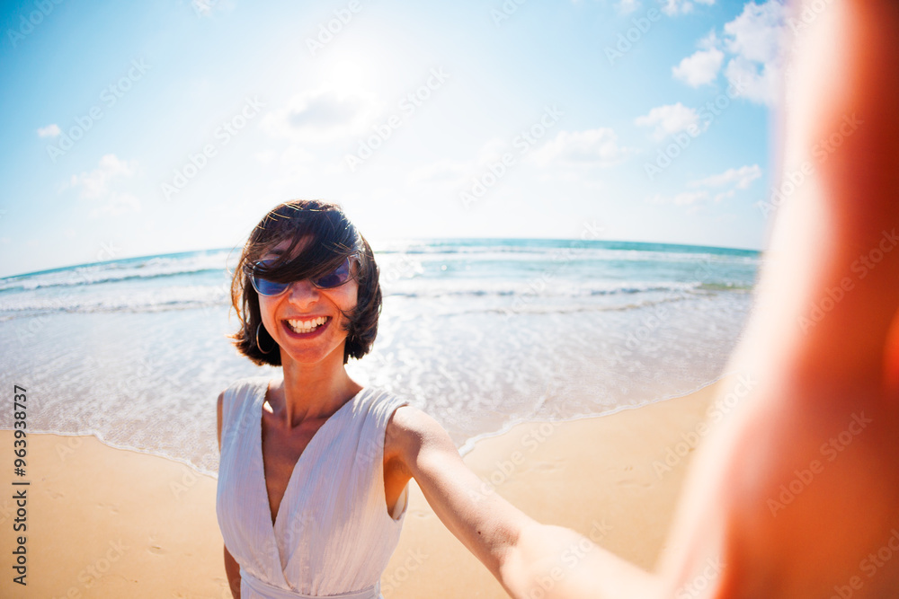 Photo of a cute surprised excited young beautiful girl walking on the beach and taking a selfie to the camera. Photo of a cute surprised excited young beautiful girl walking on the beach and taking a selfie to the camera.