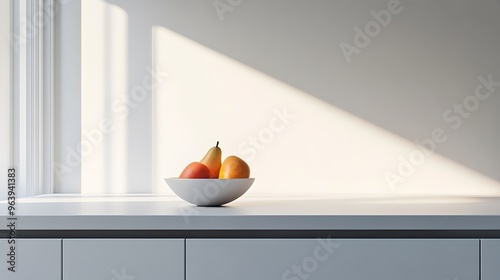 A minimalist kitchen with a clean, white countertop and a single fruit bowl