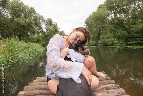 Beautiful young dark-haired girl by the river.