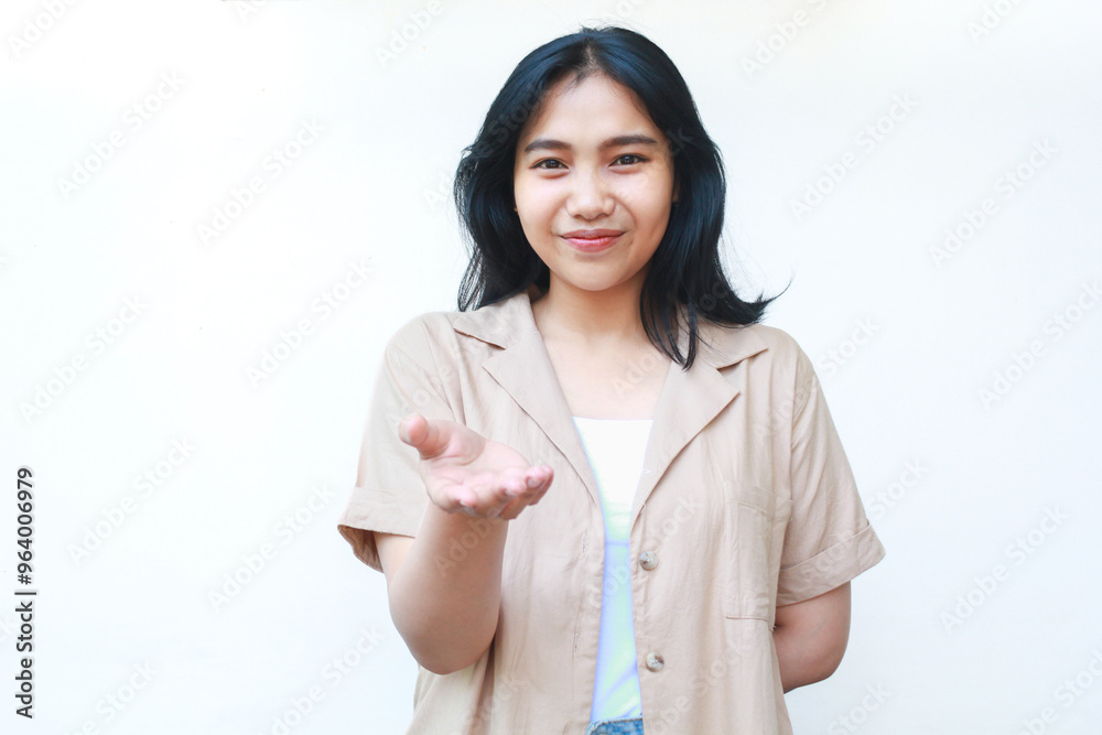 happy asian woman raising open palms at camera as inviting gesture wearing casual brown clothes isolated on white background happy asian woman raising open palms at camera as inviting gesture wearing casual brown clothes isolated on white background