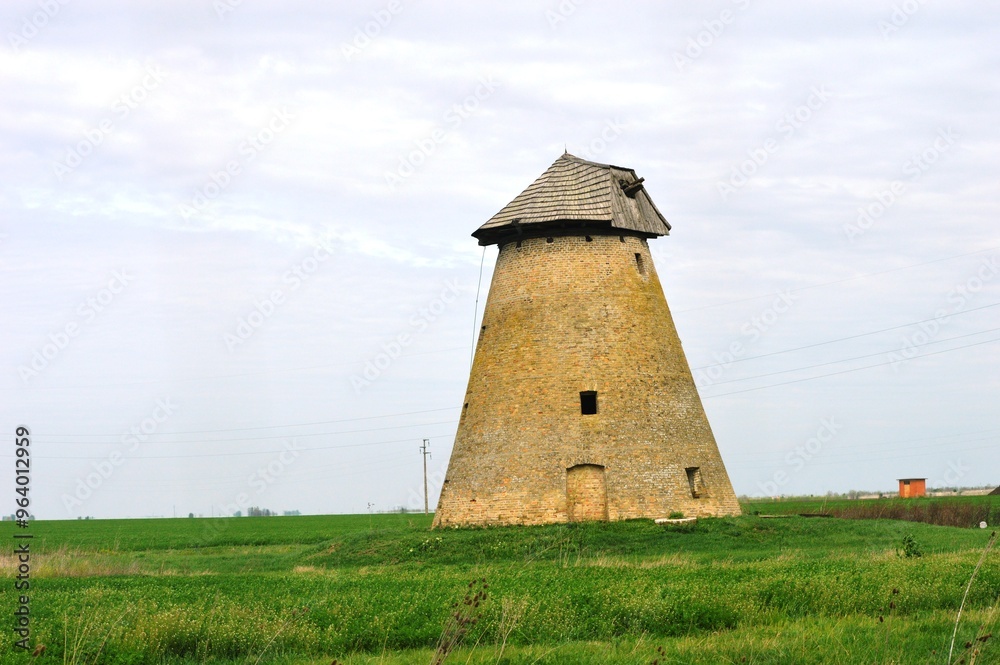 an old broken down windmill on the meadow an old broken down windmill on the meadow