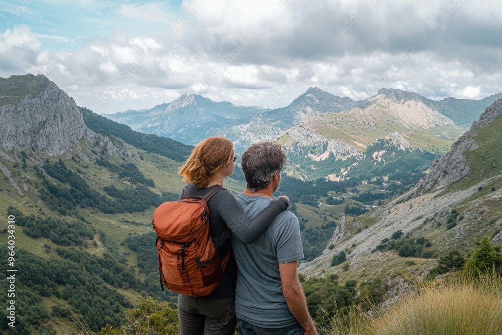 A man and woman are standing on a mountain top, looking out over the landscape. The man is wearing a backpack and the woman is wearing a backpack as well. The scene is peaceful and serene A man and woman are standing on a mountain top, looking out over the landscape. The man is wearing a backpack and the woman is wearing a backpack as well. The scene is peaceful and serene