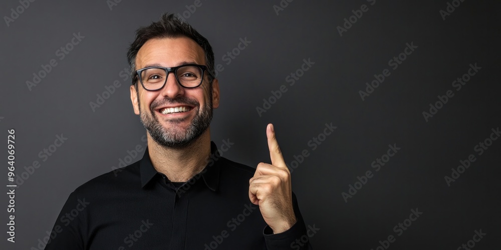 Middle-aged man pointing at gray background Middle-aged man pointing at gray background