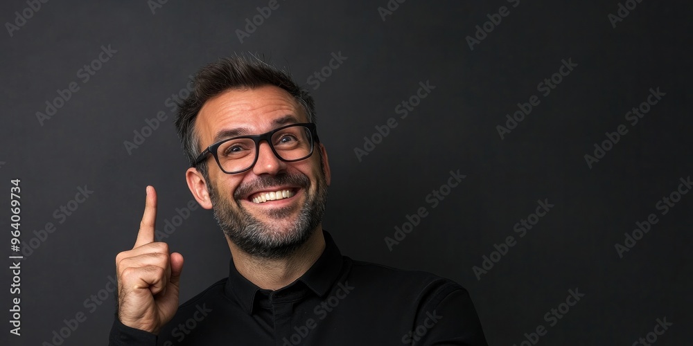 Middle-aged man pointing at gray background Middle-aged man pointing at gray background