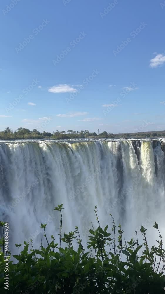 Video of the Victoria Falls, which forms the border between Zimbabwe, Zambia and Botswana. The photo was taken from the forest. A rainbow appears with the movement of the water. Video of the Victoria Falls, which forms the border between Zimbabwe, Zambia and Botswana. The photo was taken from the forest. A rainbow appears with the movement of the water.